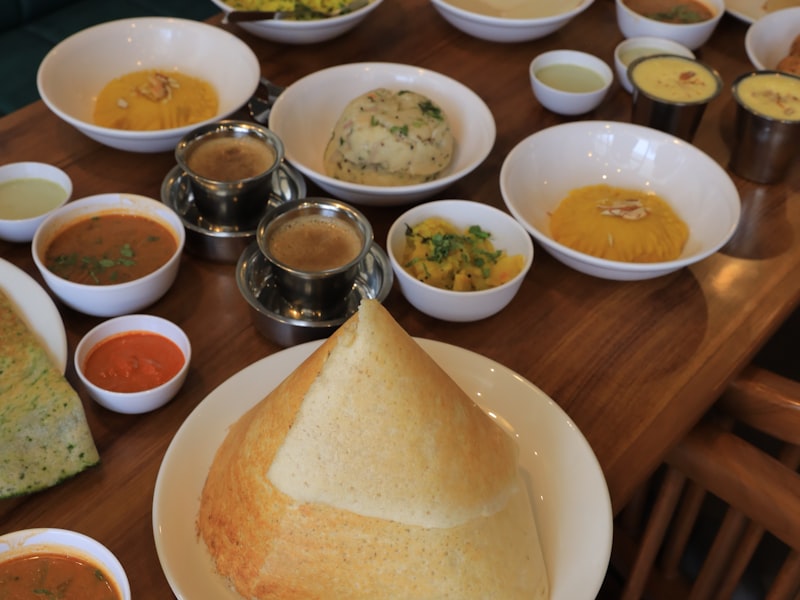 Table of South Indian vegetarian dishes laid out for a daytime function