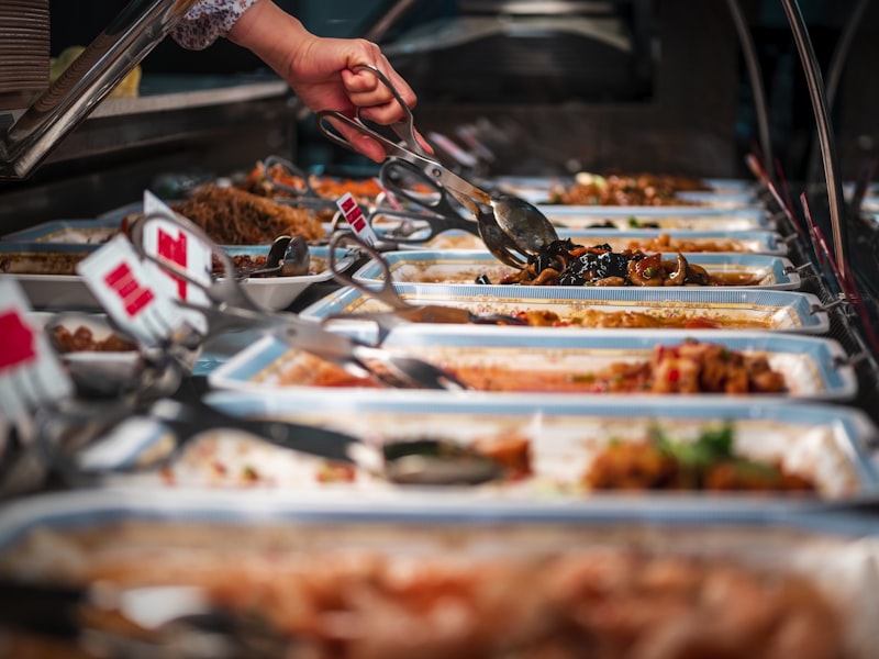 Server plating food onto a guest's plate during table service