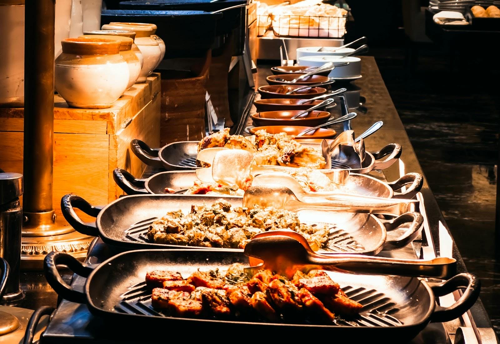 Buffet table set with many dishes of vegetarian food before service